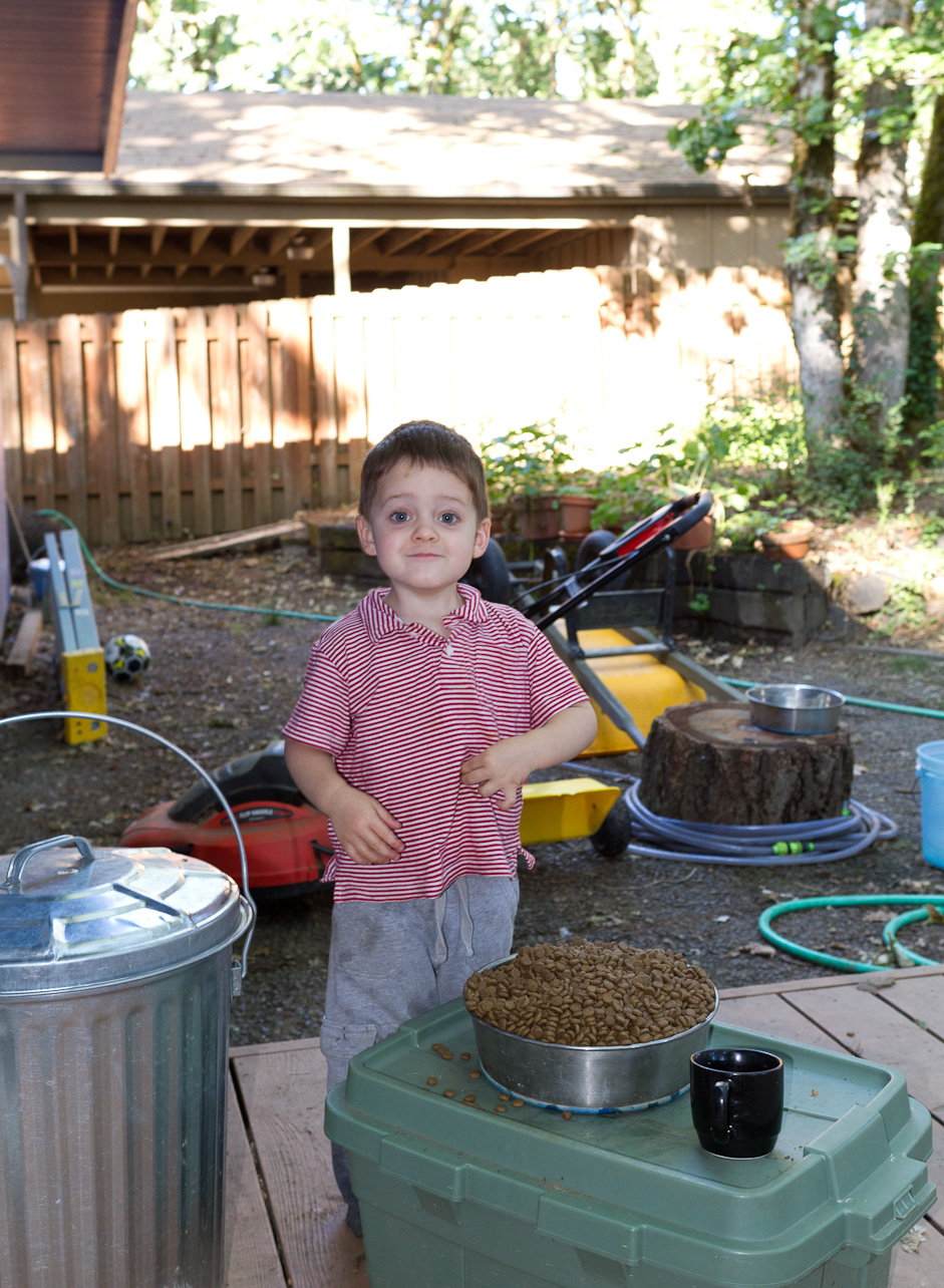 July 21, 2011 - Peter feeds the dog, Curie. He very carefully scoops the food out and into her bowl. Very carefully, and WAY too much.